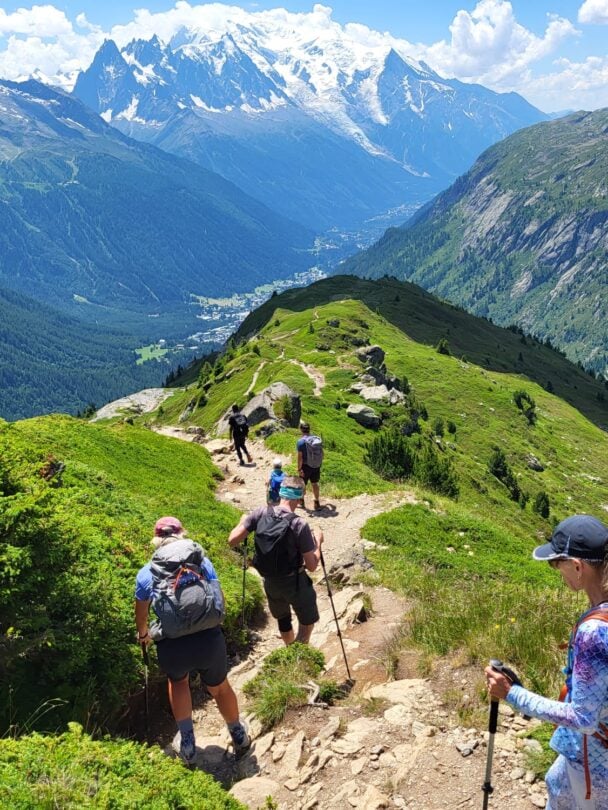 group hikers descending alps